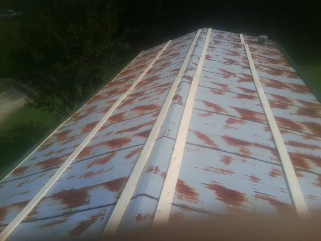 Rusted metal roof panels with new wood purlins before replacement — Storm Damage Roof Repair in Hightstown by Roofing Brothers