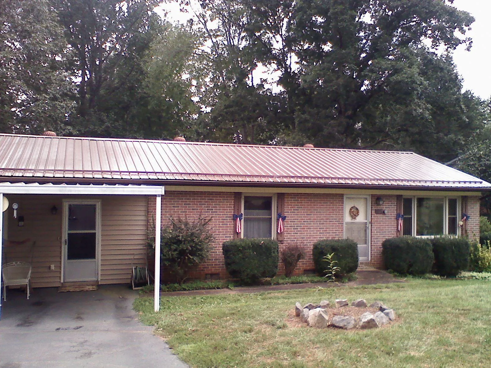 Bronze metal roof and carport on a brick ranch home — Roof Repair work by our crew in Hightstown